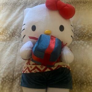 Christmas hello kitty holding a present greeter